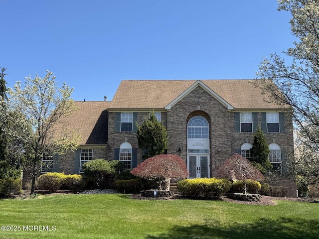 36 Graversham Dr, Marlboro, NJ 07746 - view of front of home with french doors, a front lawn, roof with shingles, and brick siding