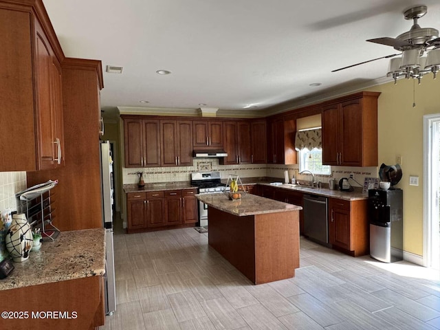 36 Graversham Dr, Marlboro, NJ 07746 - kitchen with stainless steel gas stove, dishwasher, under cabinet range hood, decorative backsplash, and a sink