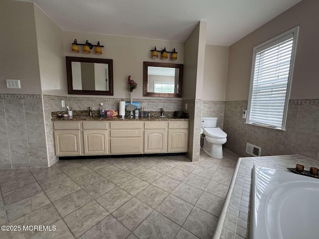 36 Graversham Dr, Marlboro, NJ 07746 - full bath with tile walls, wainscoting, tile patterned floors, double vanity, and plenty of natural light