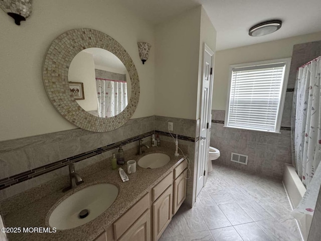 36 Graversham Dr, Marlboro, NJ 07746 - bathroom featuring tile walls, double vanity, toilet, tile patterned flooring, and wainscoting