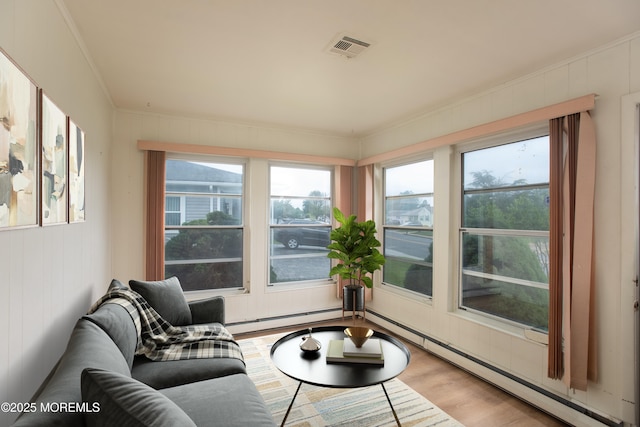 343 Barbados Dr N, Toms River, NJ 08757 - living room featuring a baseboard heating unit, wood finished floors, a baseboard radiator, plenty of natural light, and crown molding