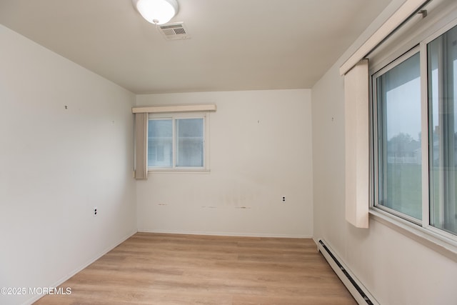 343 Barbados Dr N, Toms River, NJ 08757 - empty room with light wood-style flooring, a baseboard heating unit, and baseboards