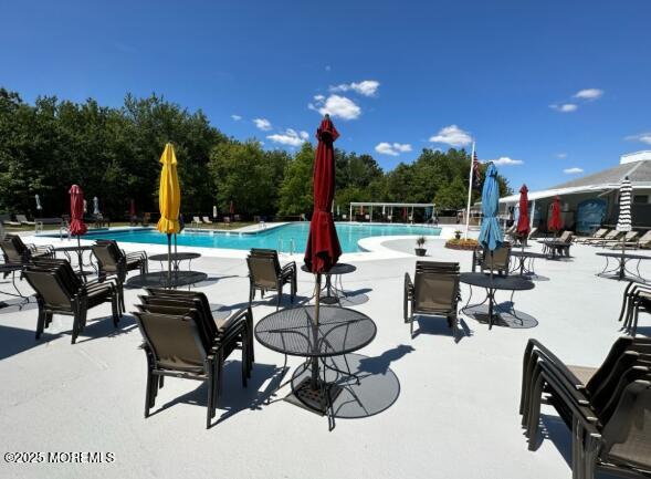 343 Barbados Dr N, Toms River, NJ 08757 - community pool featuring a patio and view of scattered trees