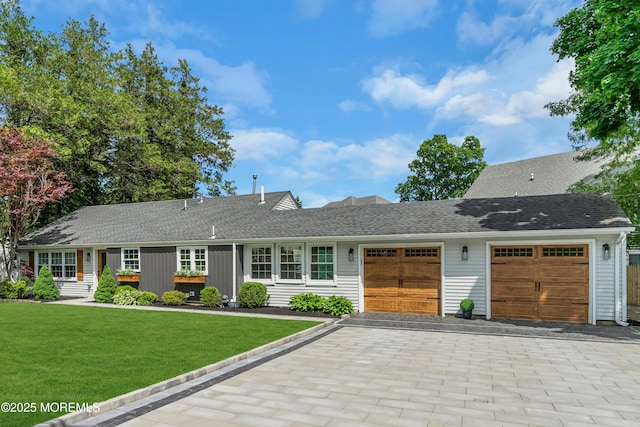 2574 Algonkin Trl, Manasquan, NJ 08736 - ranch-style house featuring an attached garage, decorative driveway, a front yard, and a shingled roof