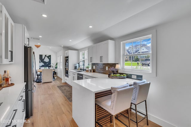 2574 Algonkin Trl, Manasquan, NJ 08736 - kitchen featuring stainless steel appliances, a breakfast bar, light wood-type flooring, white cabinetry, and recessed lighting