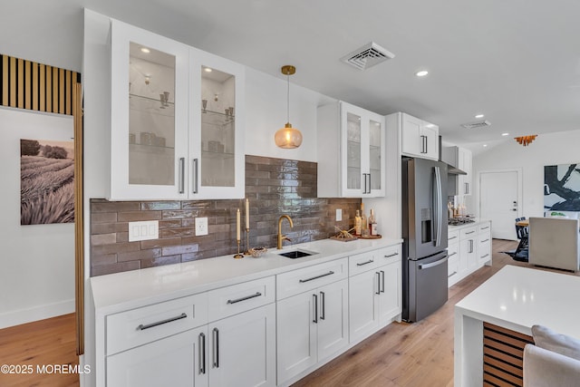 2574 Algonkin Trl, Manasquan, NJ 08736 - kitchen featuring appliances with stainless steel finishes, a sink, light wood-style flooring, decorative backsplash, and pendant lighting