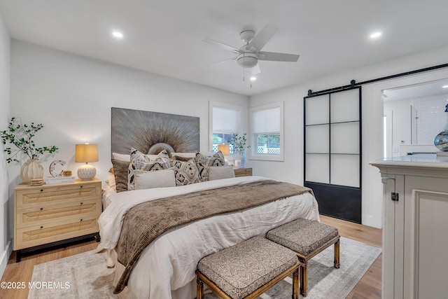 2574 Algonkin Trl, Manasquan, NJ 08736 - bedroom featuring a barn door, recessed lighting, light wood-style floors, ceiling fan, and baseboards