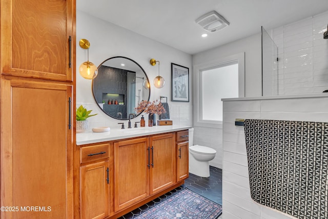 2574 Algonkin Trl, Manasquan, NJ 08736 - full bath with vanity, tile walls, tiled shower, toilet, and recessed lighting
