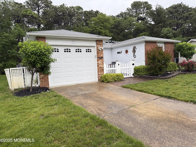 15 Tudor Ct, Brick, NJ 08723 - view of front of house with brick siding, concrete driveway, and a garage