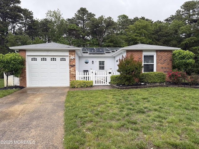 15 Tudor Ct, Brick, NJ 08723 - view of front facade featuring brick siding, a garage, driveway, and view of wooded area