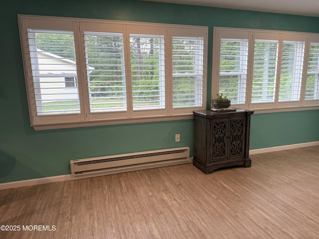 15 Tudor Ct, Brick, NJ 08723 - spare room with a baseboard radiator, light wood-style floors, baseboards, and plenty of natural light