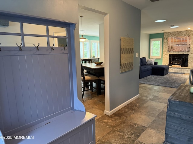 15 Tudor Ct, Brick, NJ 08723 - mudroom with baseboards, dark stone finish flooring, and a brick fireplace