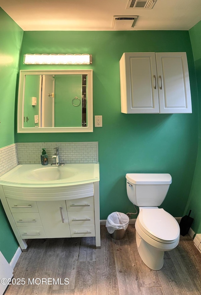 15 Tudor Ct, Brick, NJ 08723 - bathroom featuring wood finished floors, vanity, toilet, and baseboards