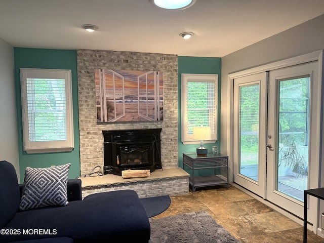 15 Tudor Ct, Brick, NJ 08723 - living area with a brick fireplace, stone finish floors, and french doors