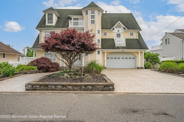834 Leeward Dr, Forked River, NJ 08731 - view of front of house with a balcony, decorative driveway, roof with shingles, and a garage