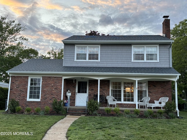 604 N Blvd, Lake Como, NJ 07719 - view of front facade featuring covered porch, a chimney, a lawn, and brick siding