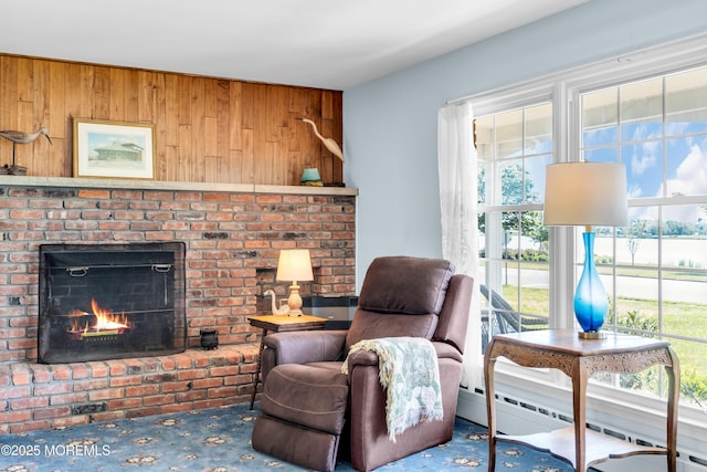 604 N Blvd, Lake Como, NJ 07719 - living area with a baseboard heating unit, wooden walls, a brick fireplace, and carpet floors