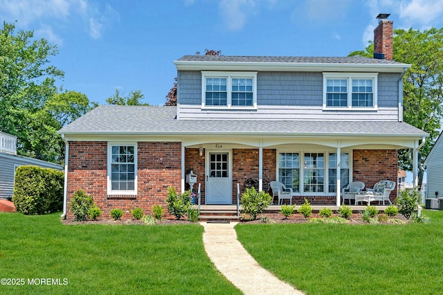 604 N Blvd, Lake Como, NJ 07719 - view of front of house featuring a chimney, covered porch, a front lawn, brick siding, and a shingled roof