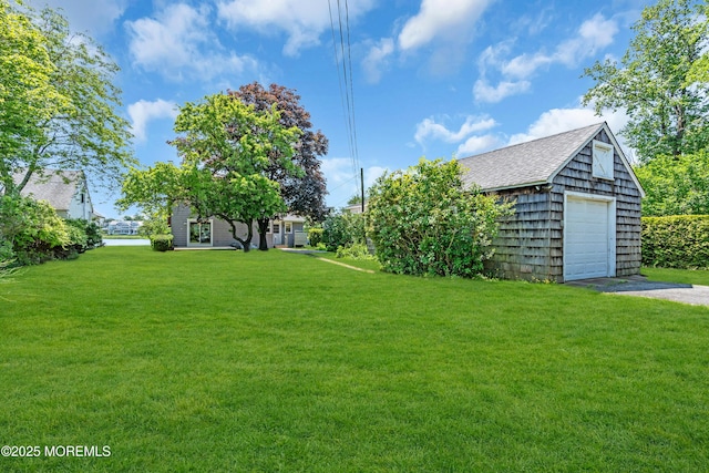 604 N Blvd, Lake Como, NJ 07719 - view of green lawn with asphalt driveway, an outdoor structure, and a garage
