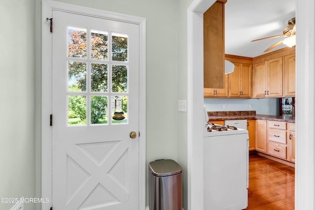 604 N Blvd, Lake Como, NJ 07719 - kitchen featuring a ceiling fan, gas range gas stove, wood finished floors, dark countertops, and light brown cabinets