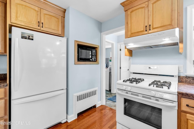 604 N Blvd, Lake Como, NJ 07719 - kitchen with white appliances, under cabinet range hood, radiator, and light brown cabinets