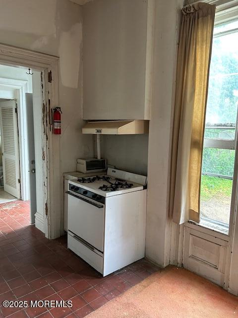 62 Washington St, Red Bank, NJ 07701 - kitchen featuring gas range gas stove, extractor fan, light countertops, and tile patterned flooring