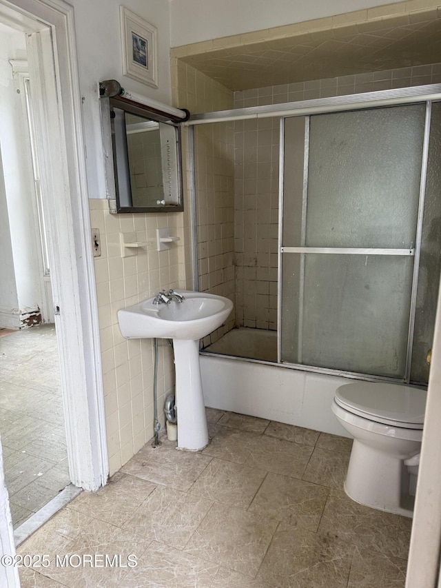 62 Washington St, Red Bank, NJ 07701 - full bath with toilet, shower / bath combination with glass door, tile walls, and a sink