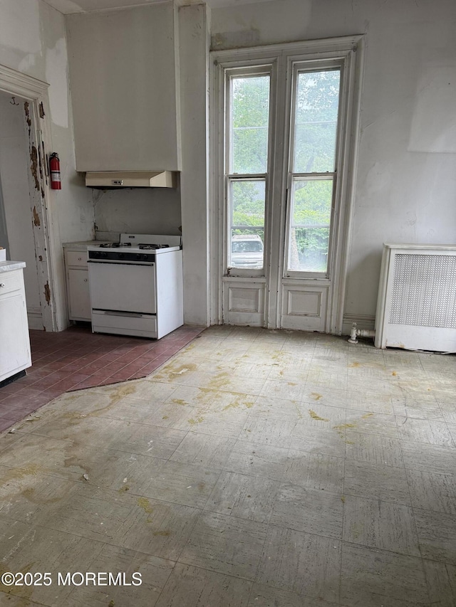 62 Washington St, Red Bank, NJ 07701 - kitchen with white range with gas cooktop, ventilation hood, radiator heating unit, and white cabinets