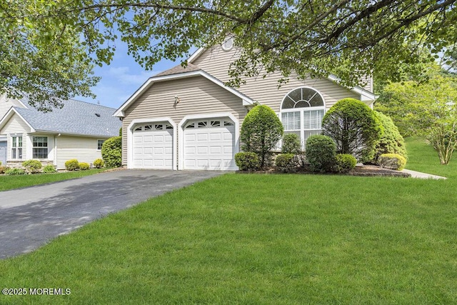 3167 Wood Spring Ln, Toms River, NJ 08755 - view of front of home featuring asphalt driveway, a garage, and a front lawn