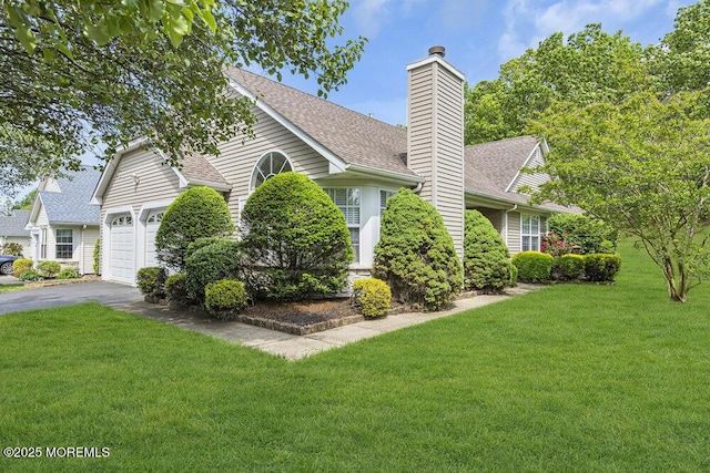 3167 Wood Spring Ln, Toms River, NJ 08755 - view of side of home with driveway, a chimney, a yard, roof with shingles, and an attached garage