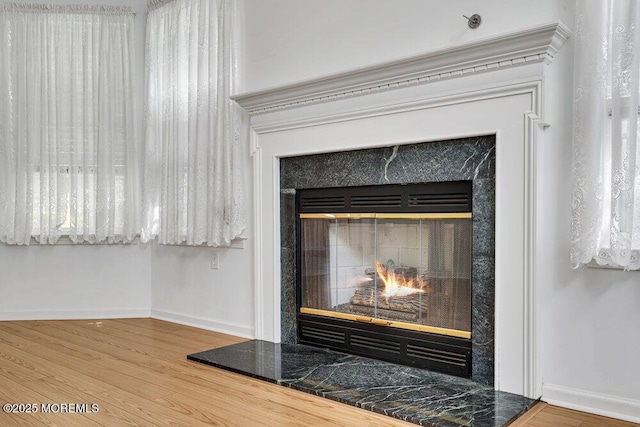 3167 Wood Spring Ln, Toms River, NJ 08755 - detailed view of a lit fireplace, baseboards, and wood finished floors