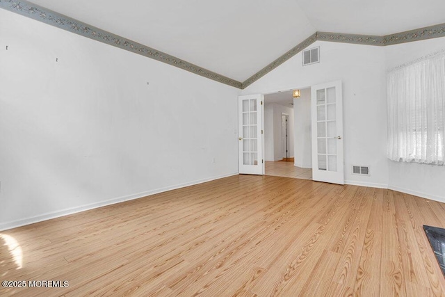 3167 Wood Spring Ln, Toms River, NJ 08755 - unfurnished room featuring french doors, lofted ceiling, wood finished floors, and baseboards