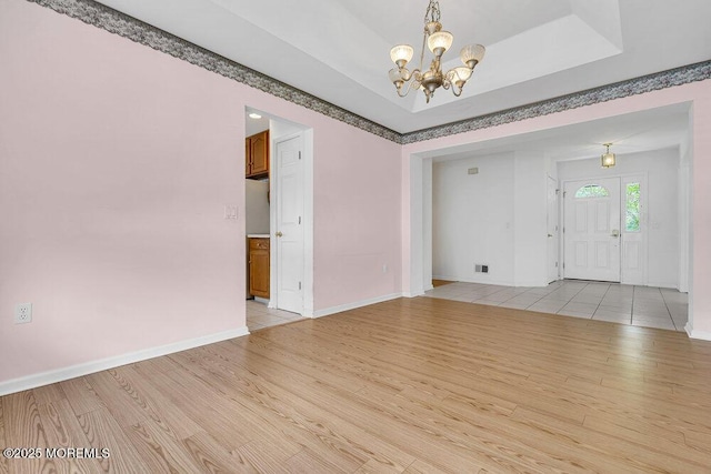 3167 Wood Spring Ln, Toms River, NJ 08755 - empty room featuring light wood-type flooring, a chandelier, and baseboards