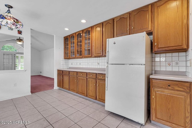 3167 Wood Spring Ln, Toms River, NJ 08755 - kitchen with freestanding refrigerator, brown cabinetry, light countertops, recessed lighting, and lofted ceiling
