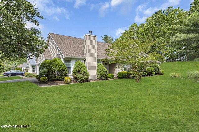 3167 Wood Spring Ln, Toms River, NJ 08755 - view of side of property featuring a chimney, a shingled roof, and a lawn
