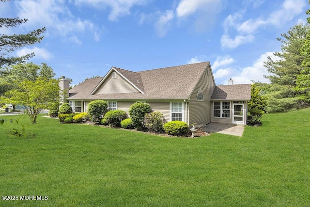 3167 Wood Spring Ln, Toms River, NJ 08755 - view of side of property with a yard, a shingled roof, a chimney, and a patio