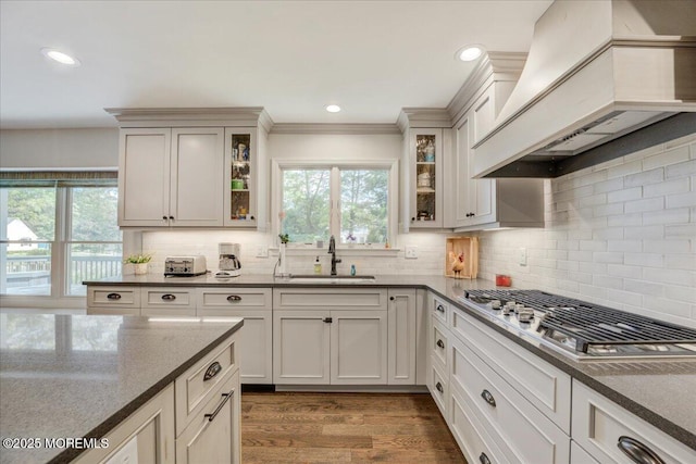 18 Vaughn Dr, Middletown, NJ 07748 - kitchen featuring stainless steel gas cooktop, custom range hood, a sink, dark stone countertops, and decorative backsplash