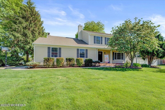 18 Vaughn Dr, Middletown, NJ 07748 - view of front of property featuring a front yard, a chimney, and a porch