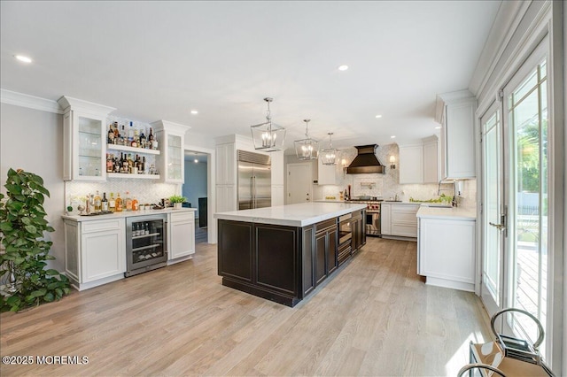 21 Northwoods Rd, Ocean Twp, NJ 07712 - kitchen featuring beverage cooler, high quality appliances, decorative backsplash, wall chimney exhaust hood, and recessed lighting