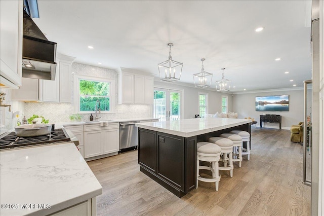 21 Northwoods Rd, Ocean Twp, NJ 07712 - kitchen featuring a sink, stainless steel dishwasher, open floor plan, a kitchen island, and white cabinetry
