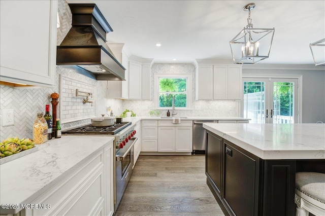 21 Northwoods Rd, Ocean Twp, NJ 07712 - kitchen with appliances with stainless steel finishes, custom range hood, a sink, decorative backsplash, and white cabinetry
