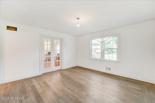 21 Northwoods Rd, Ocean Twp, NJ 07712 - unfurnished room with french doors, wood finished floors, and baseboards