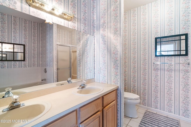73 Summerhill Dr, Manahawkin, NJ 08050 - bathroom with tile patterned floors, double vanity, toilet, a tub to relax in, and baseboards