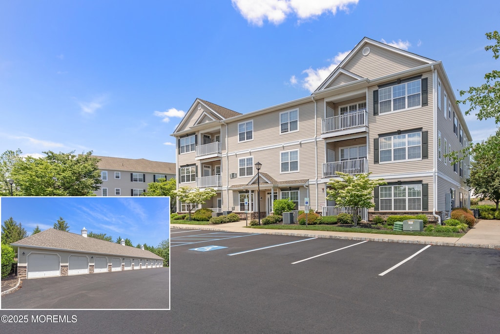 621 Mill Pond Way Unit 103, Eatontown, NJ 07724 - view of building exterior featuring uncovered parking