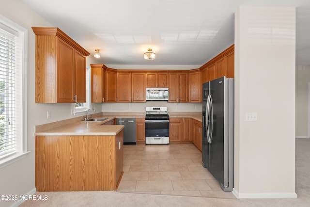 621 Mill Pond Way Unit 103, Eatontown, NJ 07724 - kitchen with appliances with stainless steel finishes, a sink, light countertops, baseboards, and light tile patterned floors