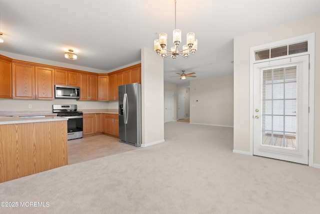 621 Mill Pond Way Unit 103, Eatontown, NJ 07724 - kitchen featuring stainless steel appliances, a chandelier, light colored carpet, light countertops, and baseboards
