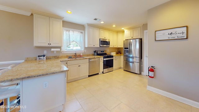 545 Hopedale Dr SW, Berkeley, NJ 08721 - kitchen with appliances with stainless steel finishes, a sink, a peninsula, light stone countertops, and a kitchen breakfast bar
