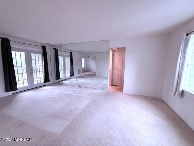 98 Beachway Ave Unit 9, Keansburg, NJ 07734 - unfurnished living room featuring french doors, carpet flooring, and healthy amount of natural light