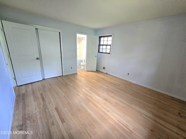 1305 Squirrel Rd, Wall, NJ 07719 - unfurnished bedroom with light wood-type flooring, baseboards, a closet, and ensuite bathroom
