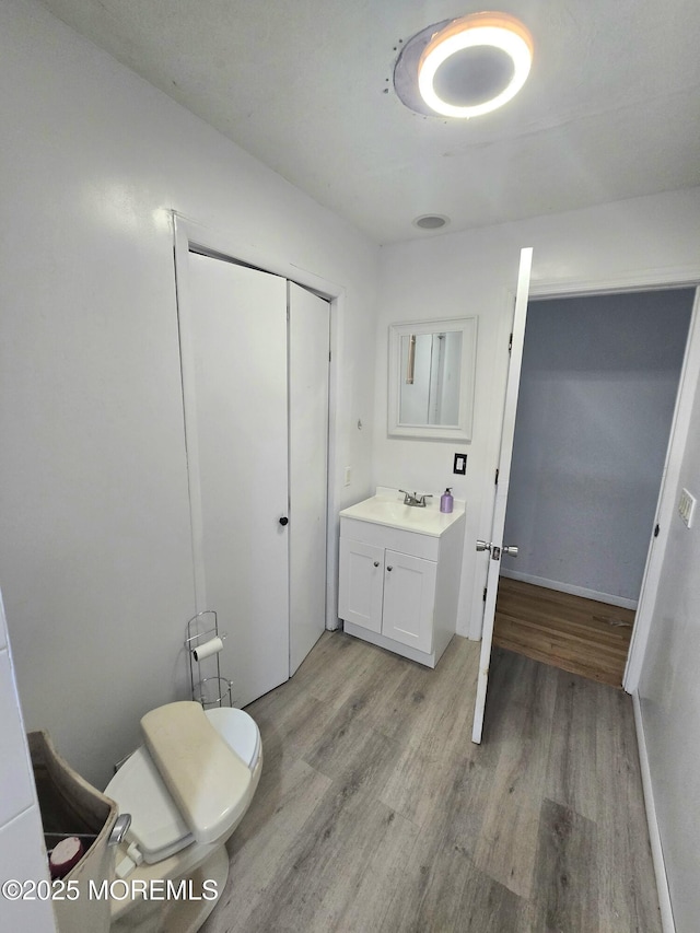 1305 Squirrel Rd, Wall, NJ 07719 - bathroom featuring wood finished floors, vanity, toilet, and baseboards